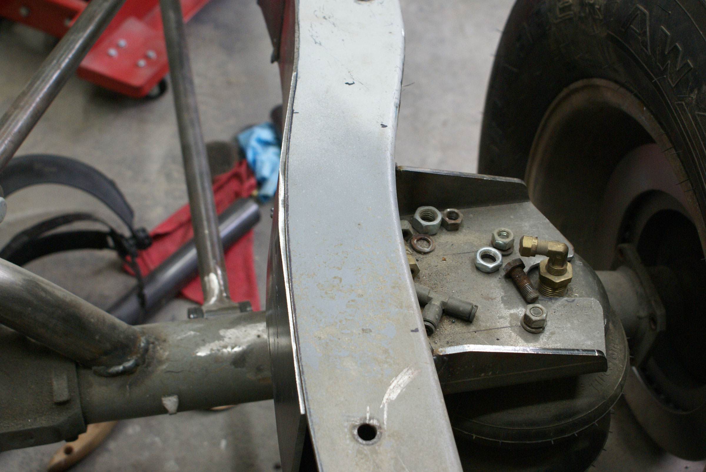 Plate that supports air bag brackets and tubing